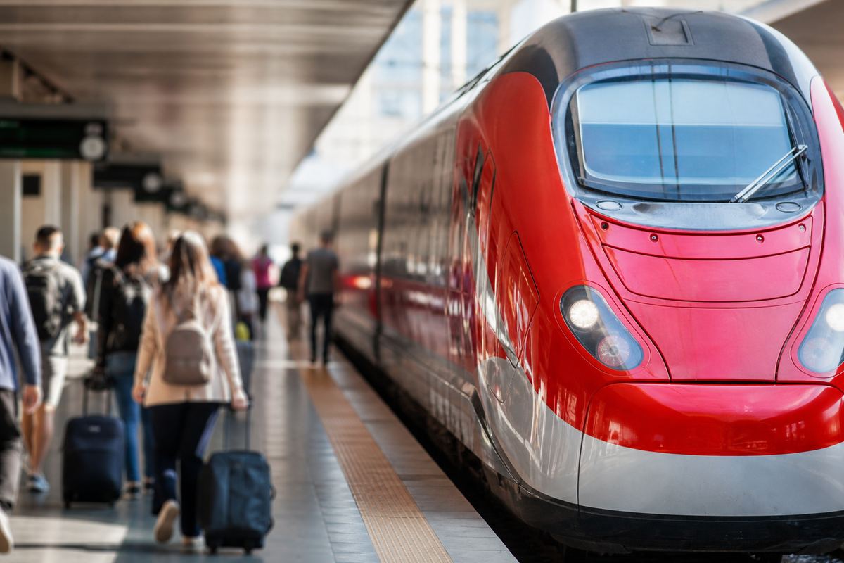 High-speed train and ancient ruins under Italian light, suggesting Rome day trips by rail or tour