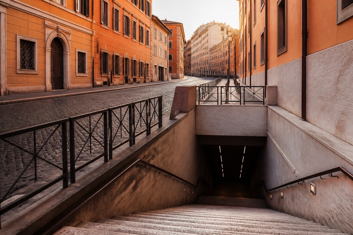 Rome metro entrance near ancient stone walls, suggesting bus, walk and rail choices in the capital