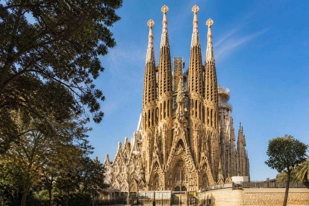 Sagrada Família towers and stone detail against a clear Barcelona sky